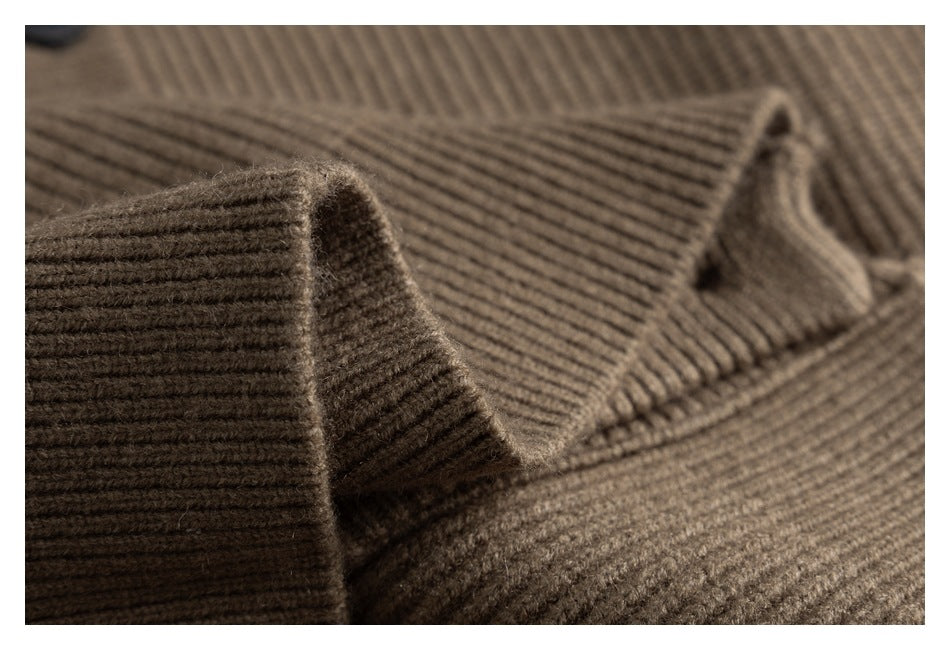 Close-up of the folded rib-knit fabric and edge of a brown cardigan.