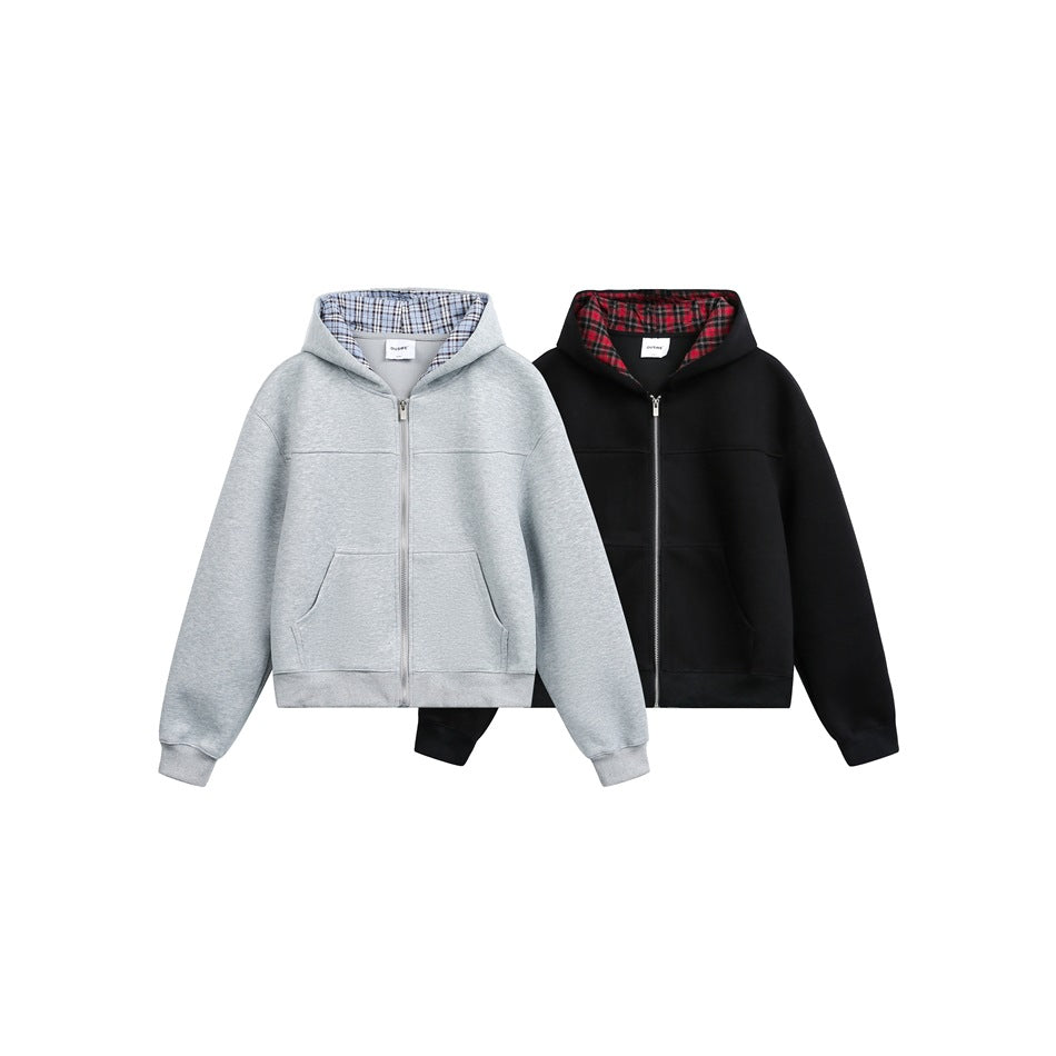 Two zip-up hoodies shown side by side: light gray with blue plaid lining and black with red plaid lining.