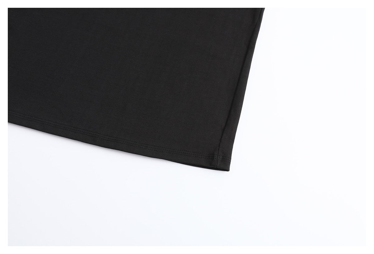 Close-up of the black T-shirt's lower hem and side seam.