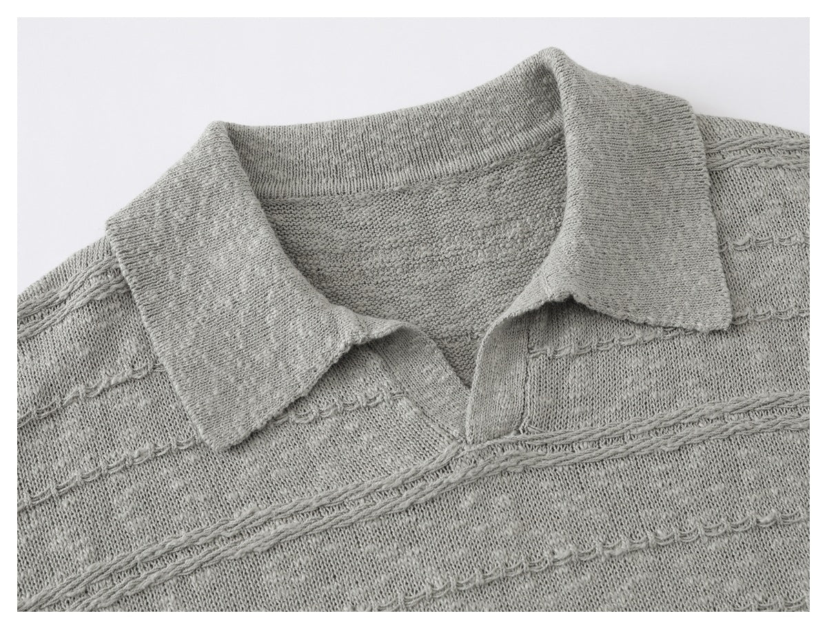 Close-up of a light gray knit polo shirt collar and textured horizontal bands.