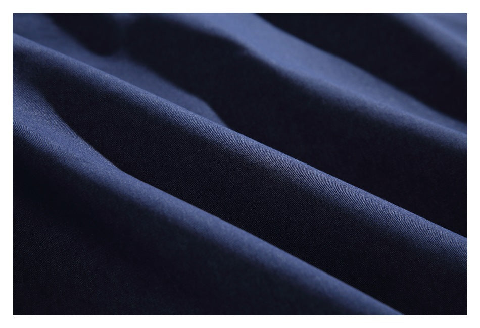 Close-up of dark navy fabric draped in smooth folds.