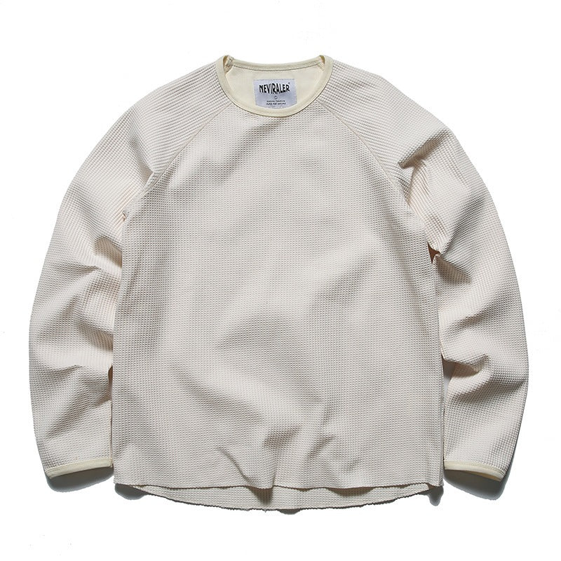 Off-white waffle-knit long-sleeve top with contrast neck and cuff binding, flat front view