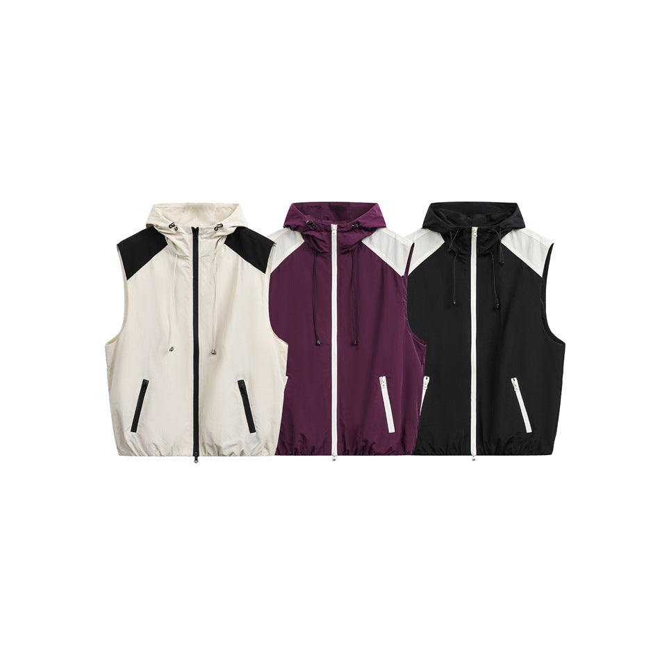 Front view of sleeveless hooded vests in cream and black, plum and cream, and black and cream colorways.