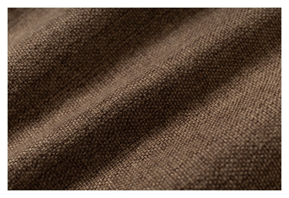Extreme close-up of the brown fabric's coarse woven texture.