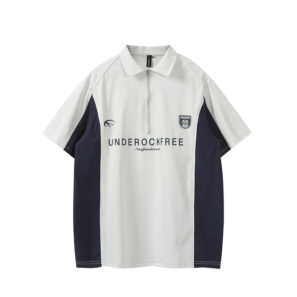 Light gray short-sleeve quarter-zip polo with navy side panels, white piping and navy chest print, front view