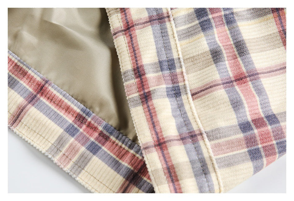 Close-up showing the jacket's smooth khaki lining beside its cream plaid outer fabric.