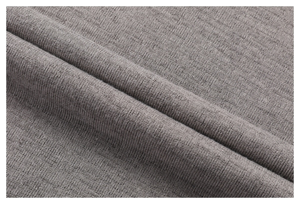 Close-up of heather gray knit fabric folded to show its texture and reverse side.