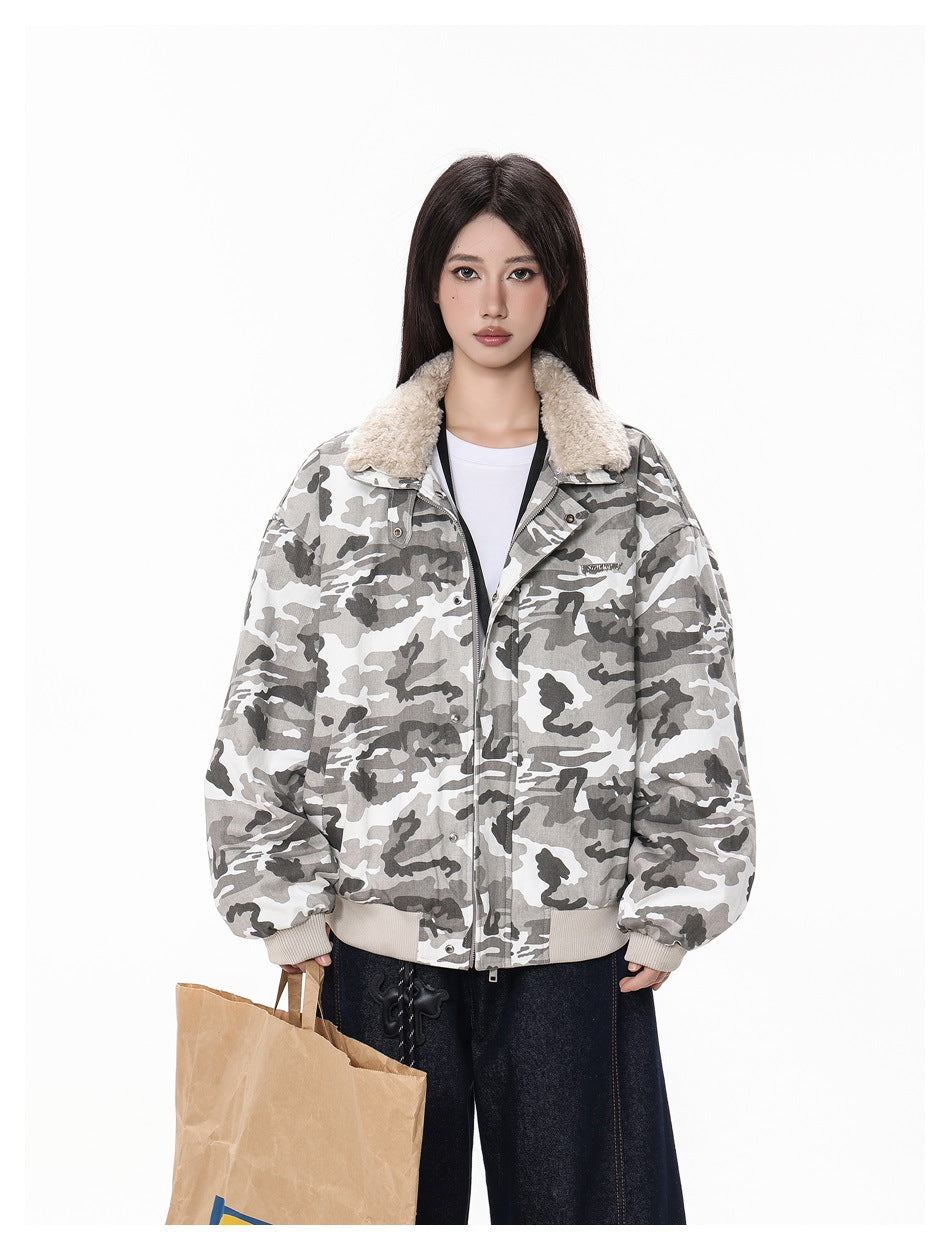 Model wearing a gray camouflage jacket with fleece-like collar, zipped front, white tee, dark jeans and a paper bag
