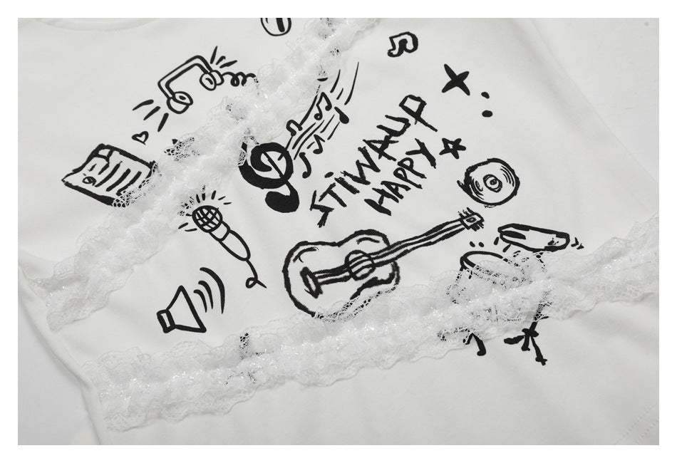 Close-up of a white T-shirt with black music-themed illustrations and decorative white lace trim.