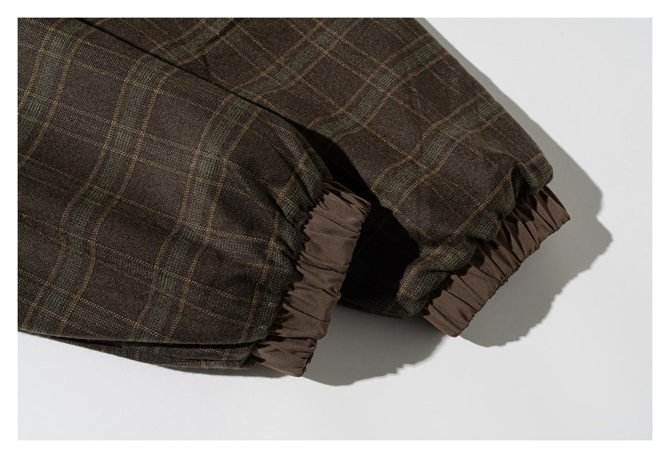 Close-up of gathered brown trim at the edges of a dark brown plaid garment.
