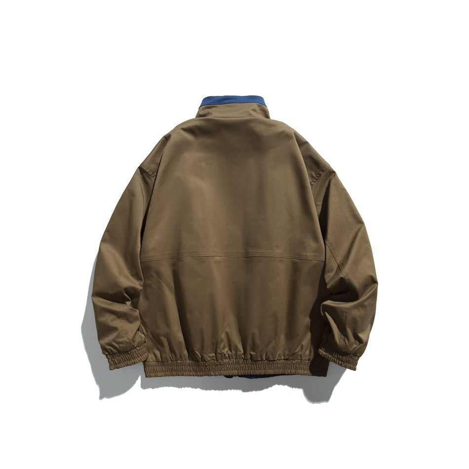 Back view of a brown jacket with a blue collar accent, seam across the back, and elastic cuffs and hem.