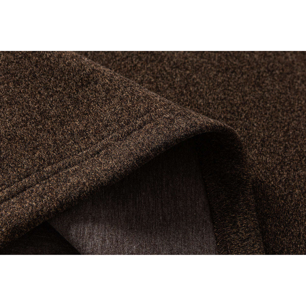 Close-up of brown heathered fabric showing a folded edge and inside surface.