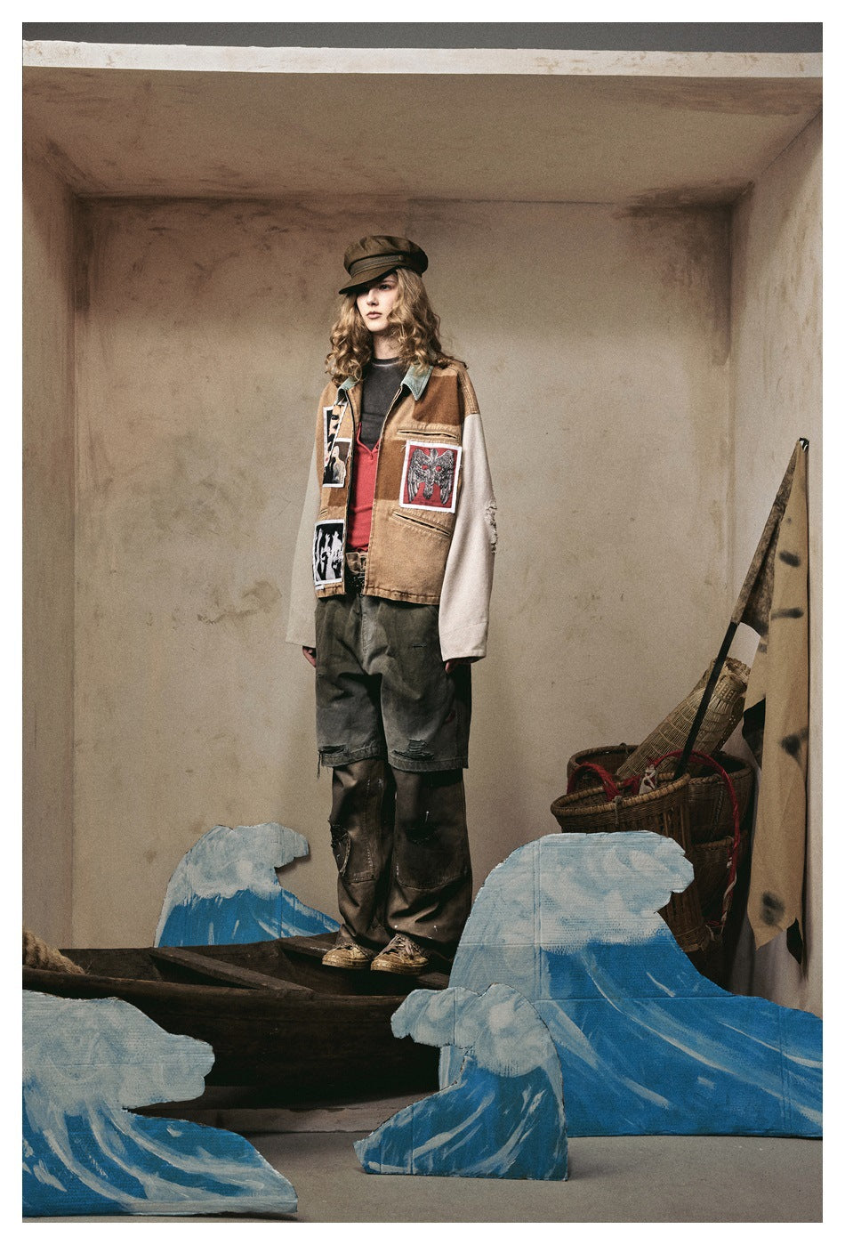 Model wearing the patchwork jacket in a three-quarter view, showing patches, pockets and light sleeves