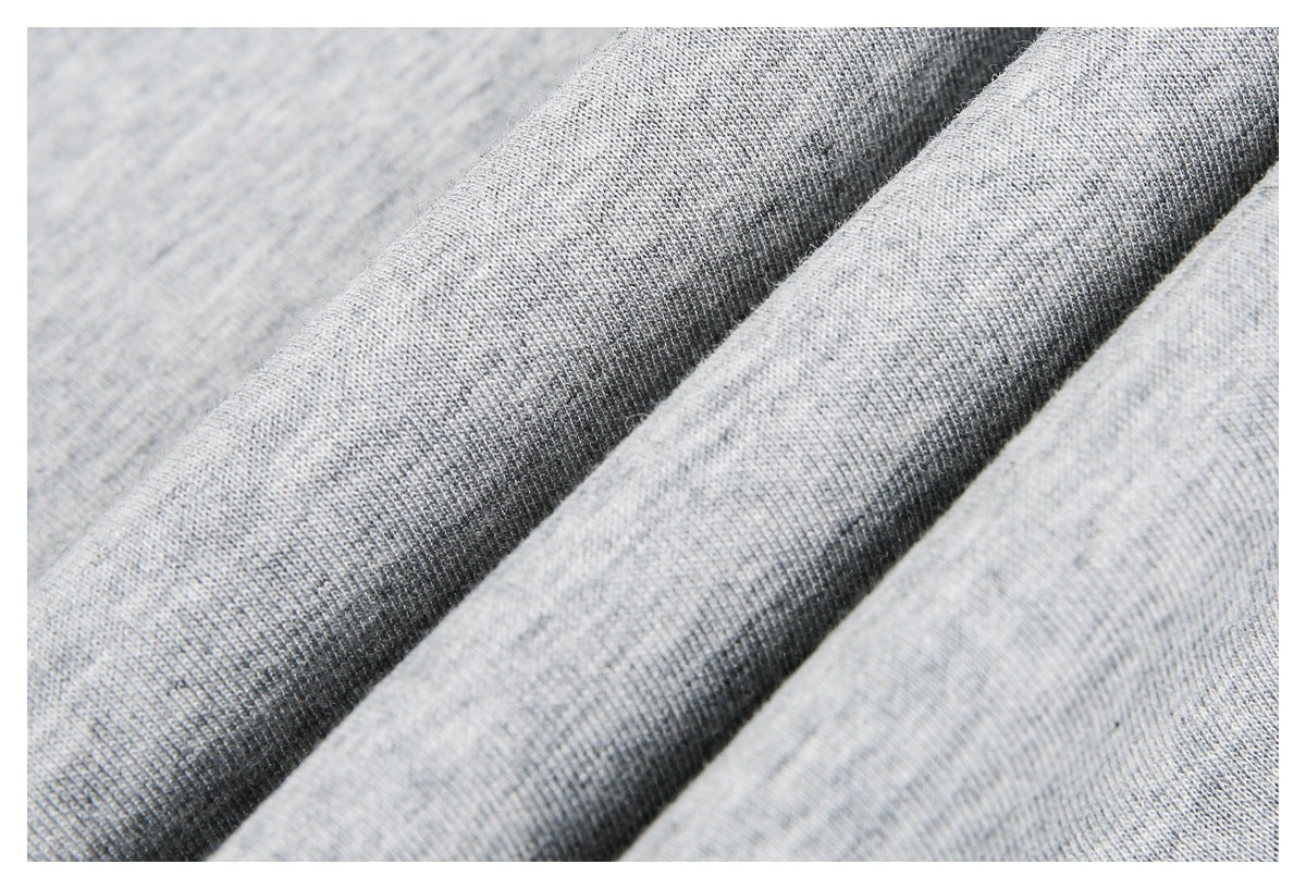 Close-up of heather gray knit fabric draped in soft folds.