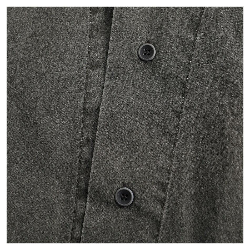 Close-up of a charcoal-gray garment's front placket with two black buttons and visible stitching.