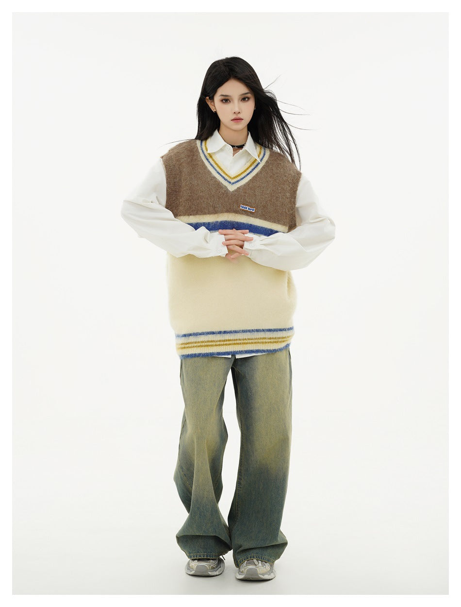 Front view of a model wearing a brown and cream V-neck sweater vest with blue and yellow stripes over a white shirt.
