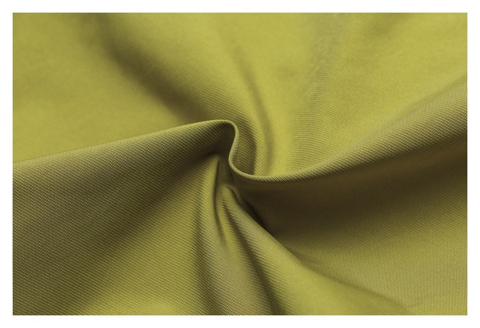 Extreme close-up of yellow-green fabric draped to show its surface and folds.