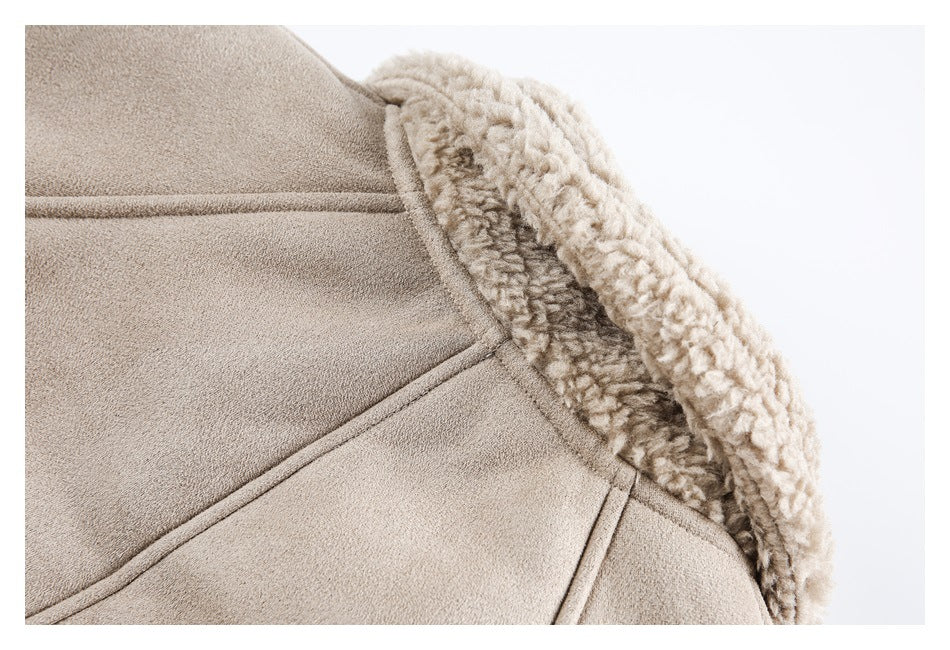 Close-up of a beige jacket collar with thick, curly cream-colored lining and stitched panels.