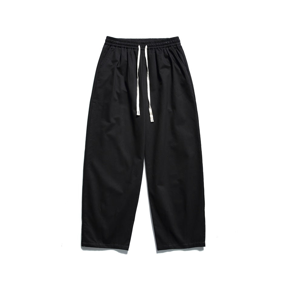 Black wide-leg drawstring pants with elastic waistband, flat lay front view