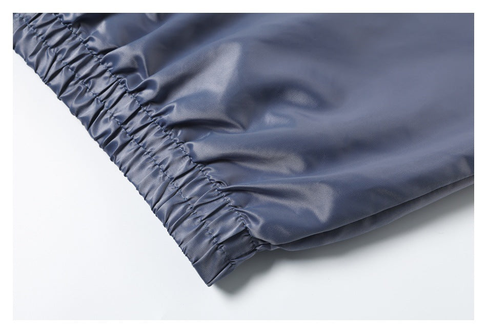 Close-up of a gathered elastic hem on slate-blue garment fabric.