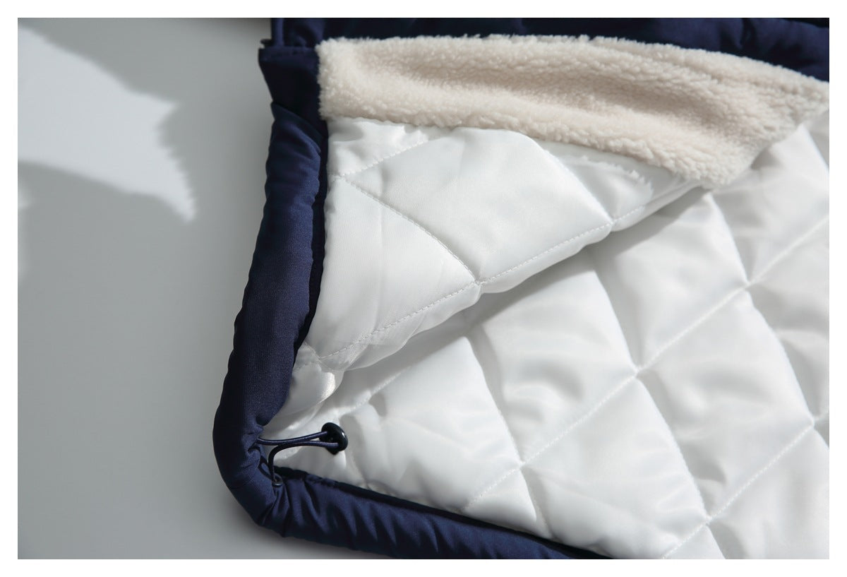 Close-up of the jacket's white quilted lining, cream fleece edge, and navy trim.