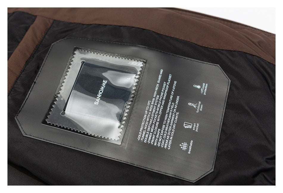 Close-up of a jacket's black inner panel with a clear label window and printed English feature text.
