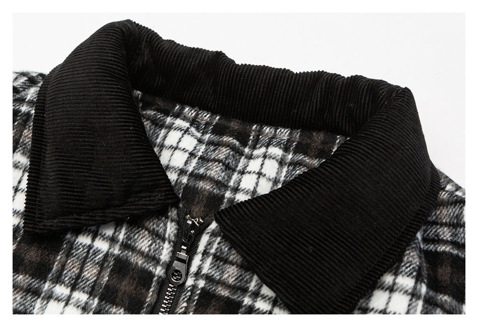 Close-up of a black ribbed collar and zipper on a black-and-white plaid jacket.