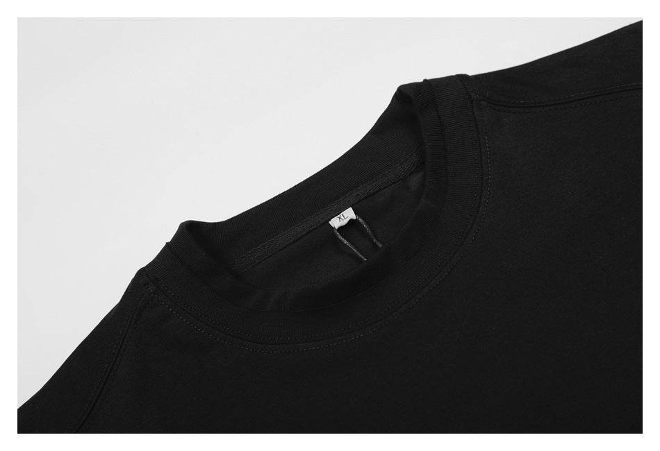 Close-up of a black crew-neck shirt collar with a small XL size tag.
