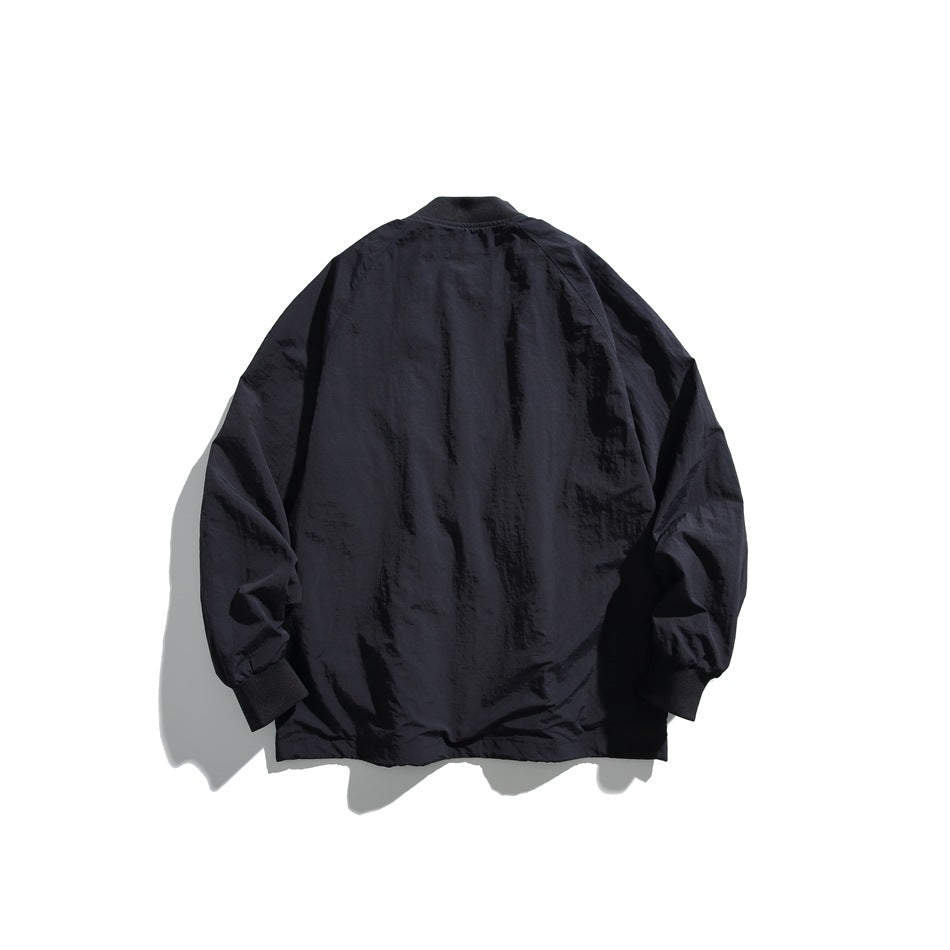 Back view of a black lightweight jacket with a short collar, long sleeves, and ribbed cuffs on a white background.