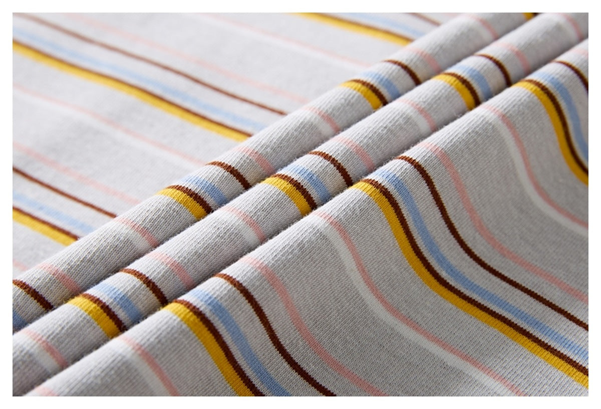 Close-up of light gray fabric with narrow horizontal stripes in yellow, blue, brown, and pink.