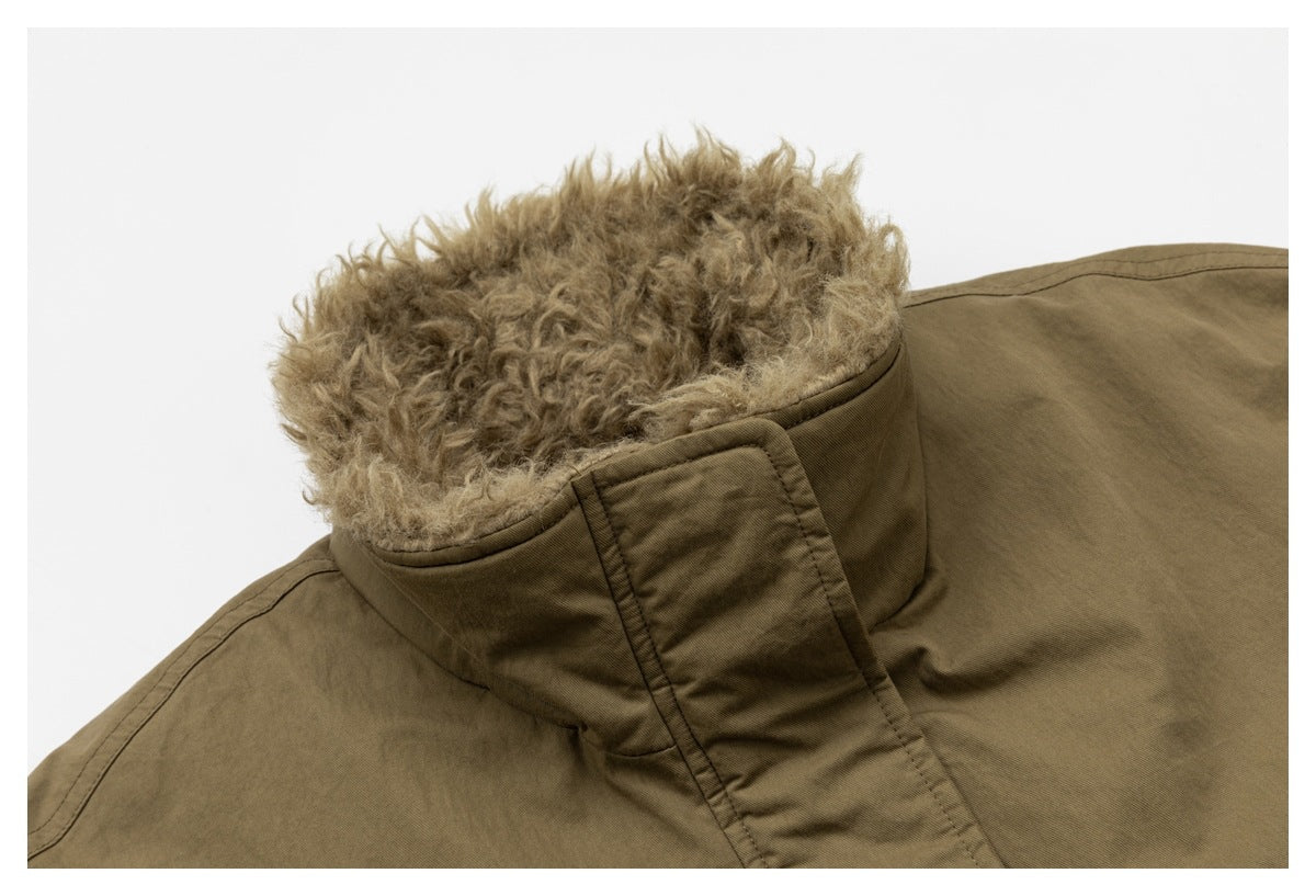 Close-up of an olive-brown coat collar lined with thick, curly tan material.