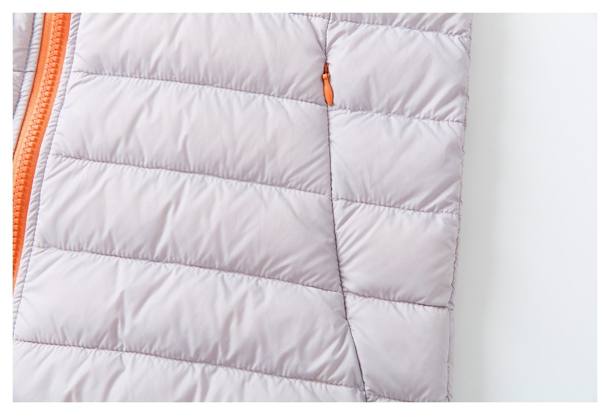 Close-up of the pale lavender quilted jacket's side pocket and small orange zipper pull.