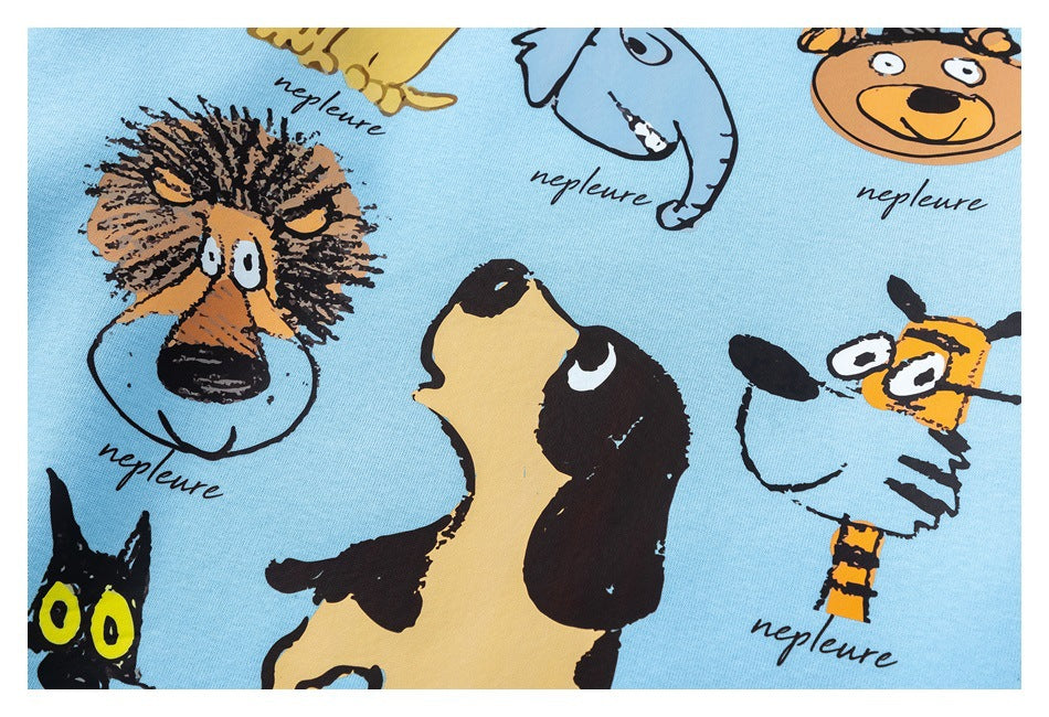 Close-up of light blue garment fabric printed with colorful cartoon animal faces and repeated English lettering.