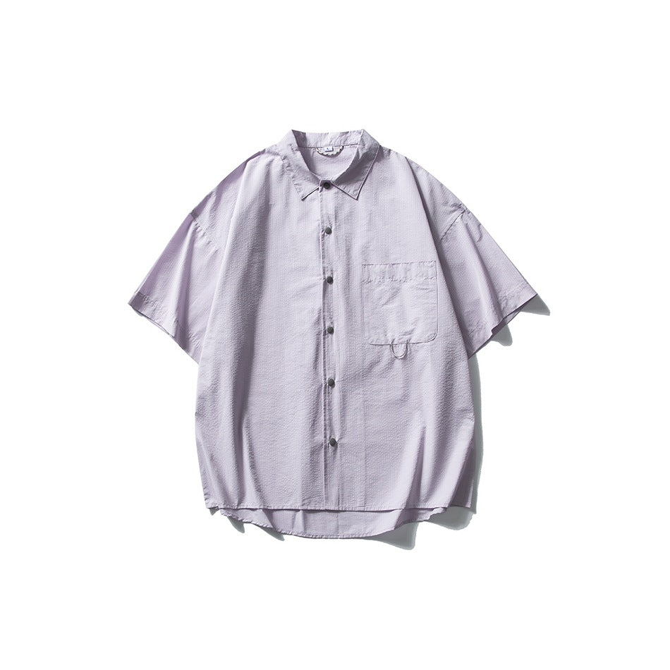 Pale lavender short-sleeve button-front shirt with collar and chest pocket, flat lay on white background