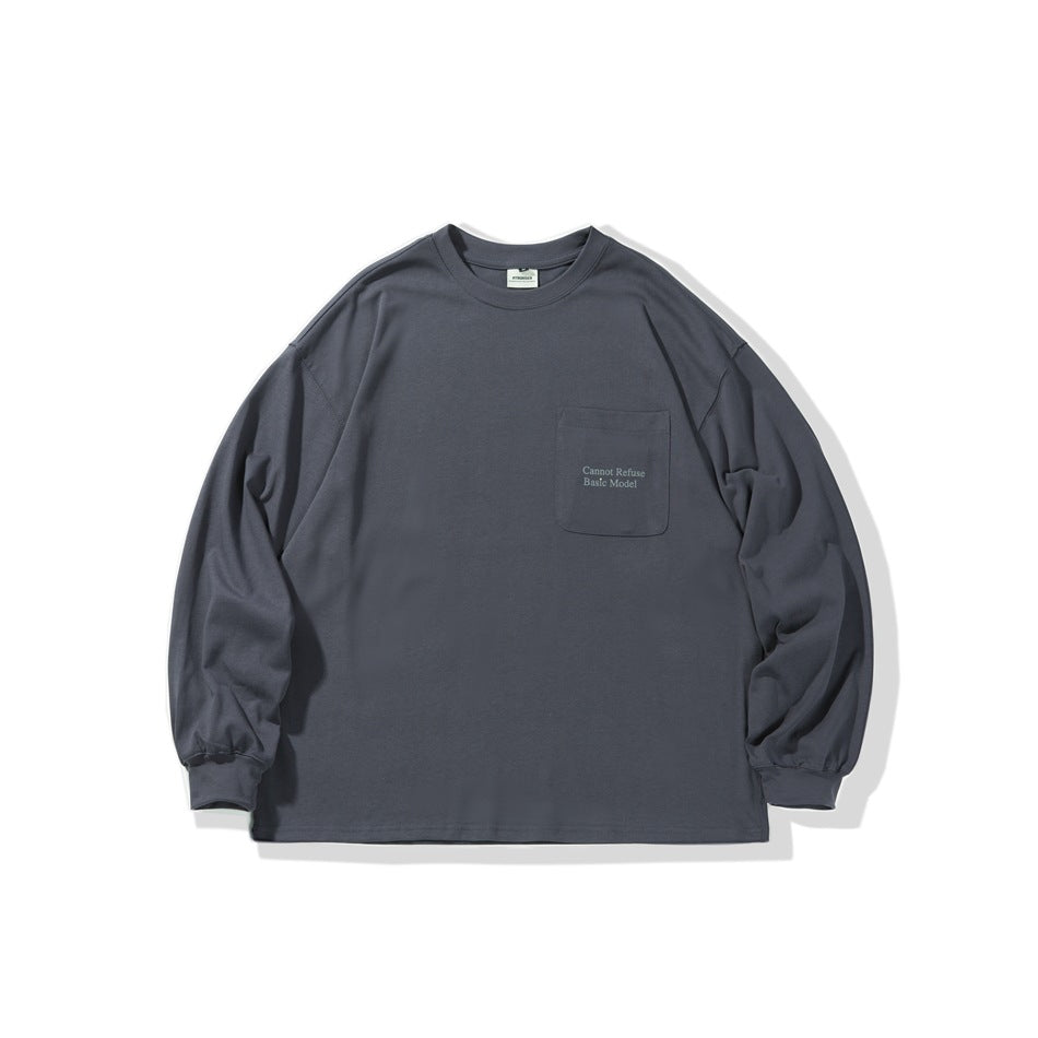 Front view of a charcoal-gray long-sleeve crewneck shirt with a chest pocket and small English text.