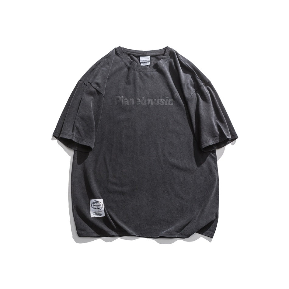 Charcoal gray short-sleeve crew-neck T-shirt with tonal chest lettering print and small white hem label, flat lay