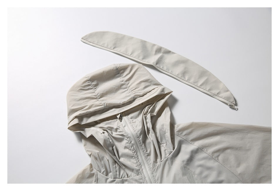 Close-up of a light beige hooded jacket and matching long zippered panel, shown against a pale background.