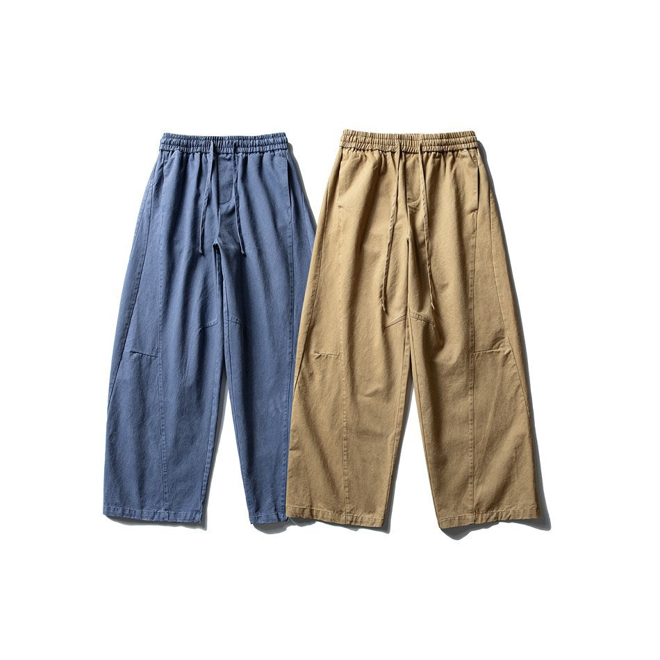 Front view of wide-leg trousers in blue and tan, both with gathered elastic waists and drawstrings.