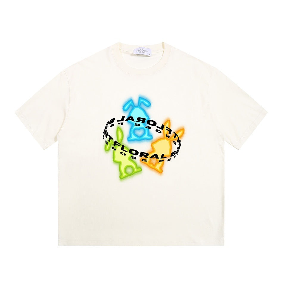 Cream short-sleeve crew neck T-shirt with a neon blue, green and orange rabbit graphic and curved lettering ring