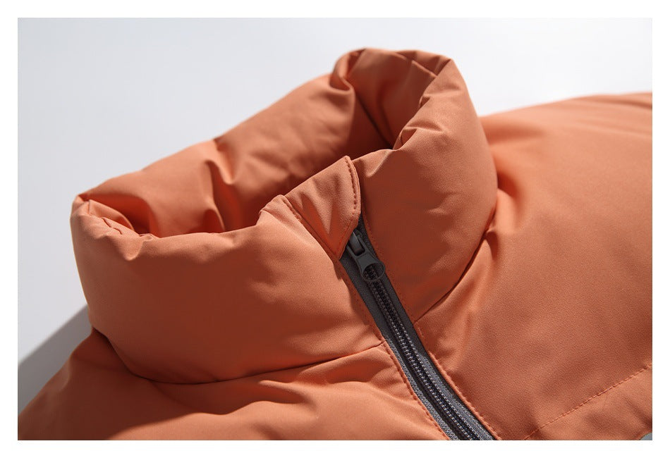 Close-up of the orange vest's padded high collar and dark center zipper.