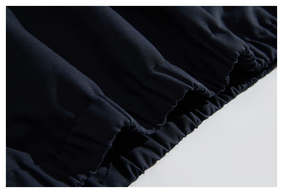 Close-up of gathered elastic edges on dark navy garment fabric.