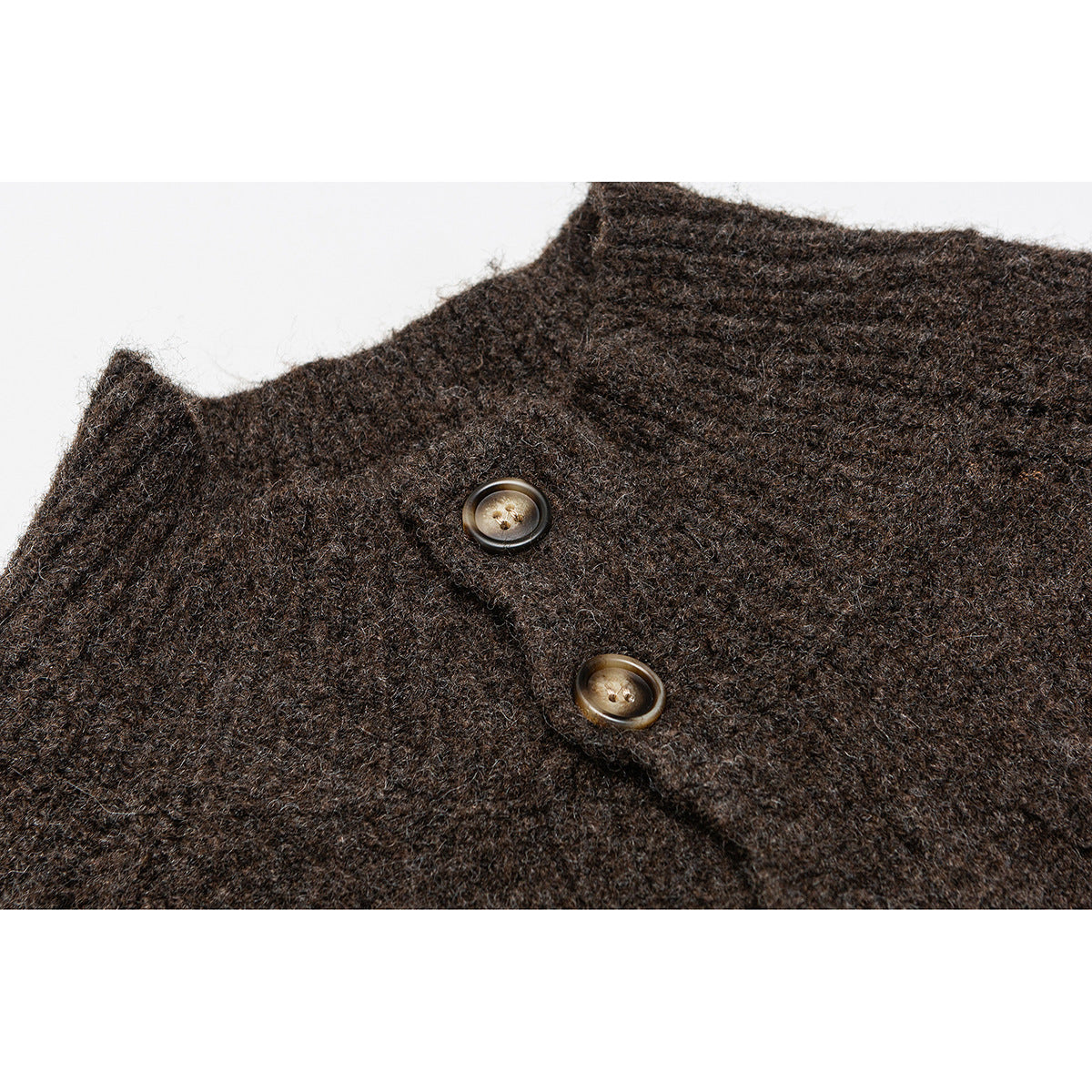 Close-up of a dark brown knit cardigan showing its collar edge and two buttons.