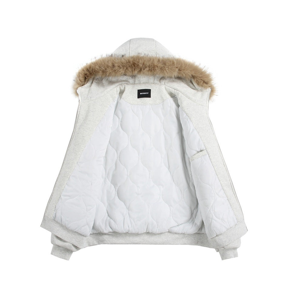 Light gray fur-trimmed jacket opened to show its white quilted lining and interior label.