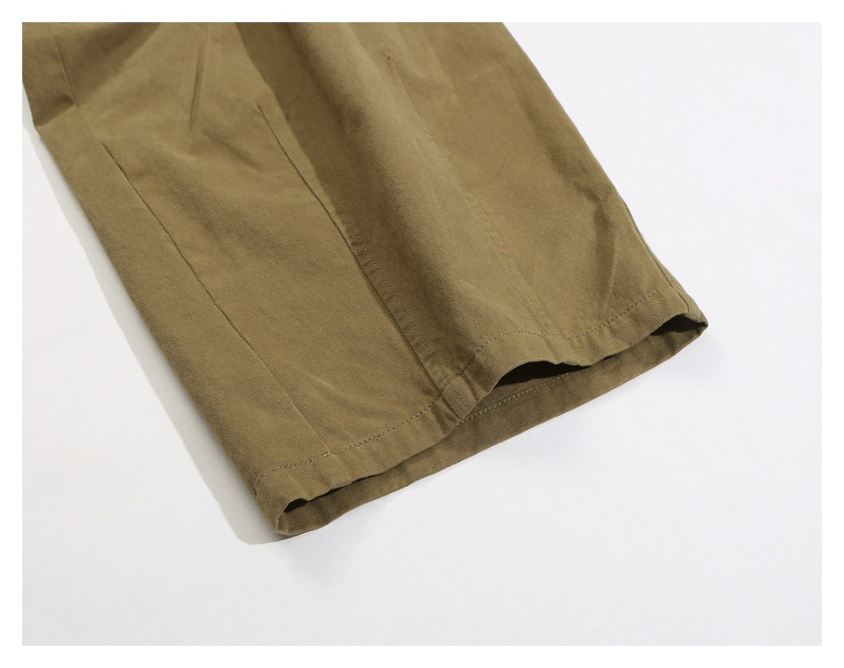 Close-up of a khaki trouser leg hem and stitching.