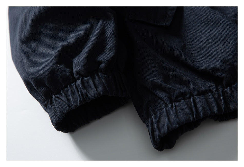 Close-up of the navy jacket's gathered elastic cuff and hem.