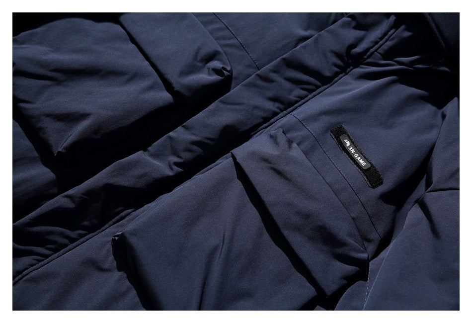 Close-up of a dark navy jacket pocket and a small sewn black label.