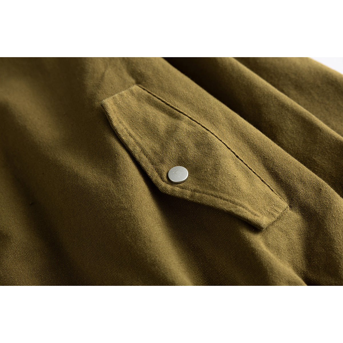 Close-up of an olive-brown jacket pocket flap with a silver snap fastener.