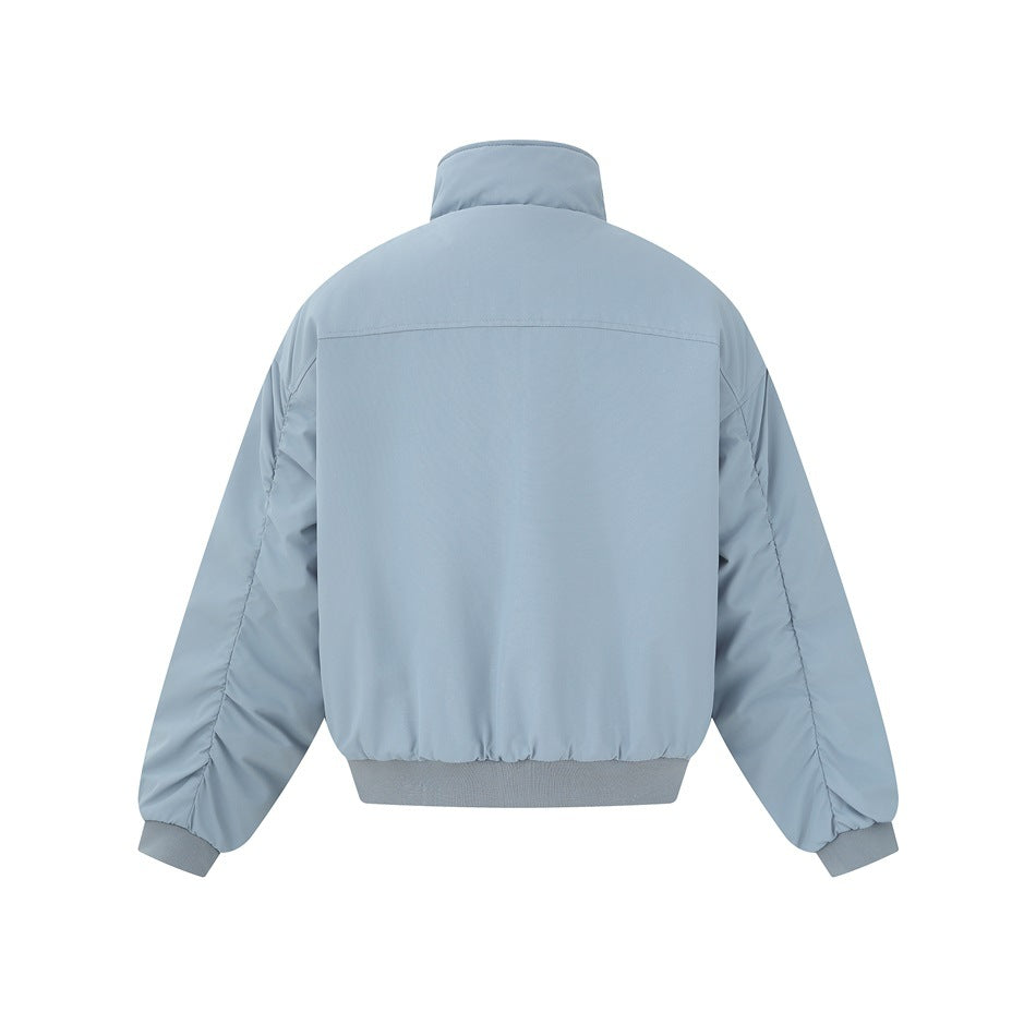 Back view of a light blue-gray zip jacket with a stand collar, long sleeves, and ribbed cuffs and hem.