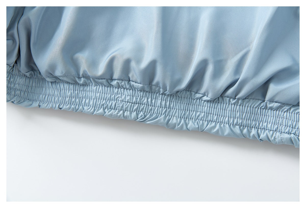 Close-up of the pale blue jacket's elasticated hem with multiple rows of stitching.