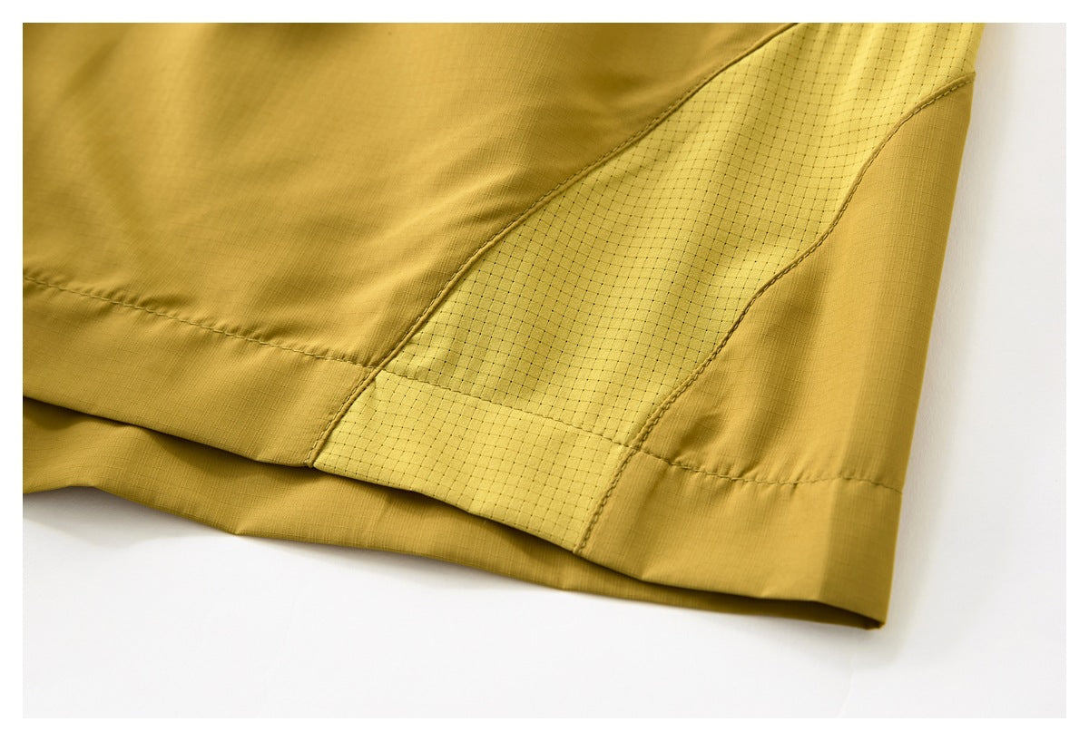 Close-up of mustard-yellow garment hem with a contrasting light-yellow grid-textured panel.
